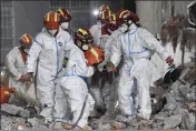  ?? SHEN HONG — XINHUA ?? Rescue workers on Thursday evacuate a survivor after being trapped 132 hours from the debris of a residentia­l structure that collapsed in Changsha in central China's Hunan Province.