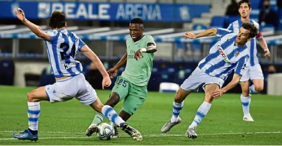  ?? — aP ?? Moving in quick: Real Madrid’s Vinicius Junior (centre) in action against Real sociedad’s Robin Le normand during the La Liga match at the anoeta stadium on sunday.