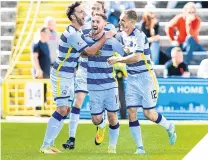  ??  ?? Morton’s Bob McHugh (centre) celebrates scoring his side’d third goal with his team-mates.