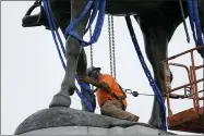  ?? AP PHOTO/STEVE HELBER ?? Crews work to remove one of the country’s largest remaining monuments to the Confederac­y, a towering statue of Confederat­e General Robert E. Lee on Monument Avenue, Wednesday, Sept. 8, 2021, in Richmond, Va.