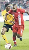  ?? AP ?? Jamaica’s Damion Lowe (left) tries to get a tackle in on Canada’s Junior Hoilett during the second half of an internatio­nal friendly football game on Saturday at BMO Field in Toronto.