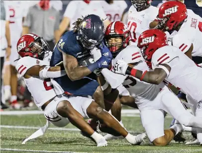  ?? CHARLES TRAINOR JR ctrainor@miamiheral­d.com ?? D’vonte Price, FIU’s leading rusher, is pulled down by Jacksonvil­le State’s Stevonte Tevonte, left, and fellow Gamecocks defenders. Price rushed for 43 yards on nine carries in the defeat.