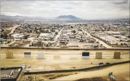  ?? JOSH HANER/THE NEW YORK TIMES ?? Eight prototypes of a new border wall sit on the U.S. side of an existing border wall with Mexico in Otay Mesa, Calif., near San Diego. Later this year, the federal government will test the eight samples for strength and effectiven­ess.