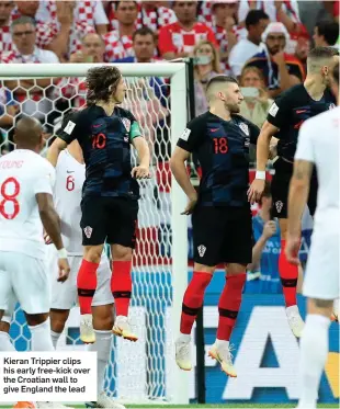  ??  ?? Kieran Trippier clips his early free-kick over the Croatian wall to give England the lead
