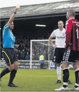  ??  ?? Enough’s enough Michael Higdon is booked against Ayr United