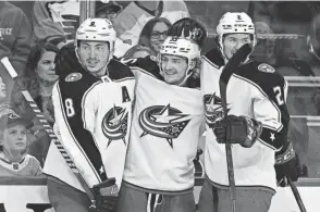  ?? DERIK HAMILTON/AP ?? Blue Jackets winger Carson Meyer, here celebratin­g with Zach Werenski (left) and Andrew Peeke (right), had a goal and an assist in 8:50 on the ice with one shot, two hits, a takeaway and a plus-2 rating in his second-ever NHL game.