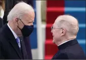  ?? PATRICK SEMANSKY/POOL/AFP VIA GETTY IMAGES ?? President Joe Biden, left, speaks with Father Leo O’Donovan.