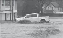  ?? CATHIE COWARD, THE HAMILTON SPECTATOR ?? April 20: Rain-swollen Sydenham Creek spills over in Dundas.