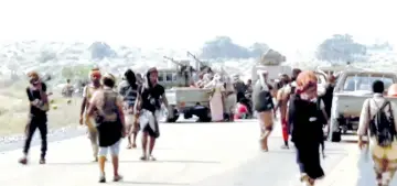  ?? — Reuters photo ?? Yemeni government fighters gather around armoured vehicles during heavy fighting in this still image taken from video.