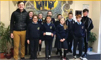  ??  ?? Gearóid Campbell of Drogheda Wheelers presents Ruth Daly, principal, and students of Donore National School with a cheque for €1,000 raised from the recent Louth Coastal Tour Cycle.