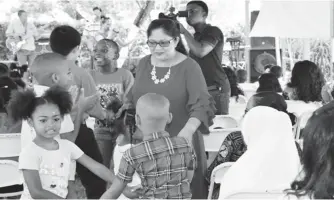  ?? (DPI photo) ?? Two hundred feted at Mrs. Nagamootoo’s party for children. The Lawns of the Prime Minister’s Residence came alive on Saturday afternoon as Sita Nagamootoo (centre), wife of Prime Minister Moses Nagamootoo and their family hosted a Christmas Party for...
