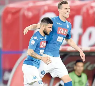  ??  ?? Napoli’s Lorenzo Insigne (left) celebrates with his teammate Arkadiusz Milik after scoring during the Serie A match against Udinese in Naples, Italy, yesterday.