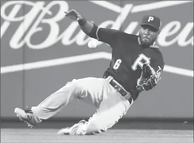  ?? Associated Press ?? All-Star suspended: Pittsburgh Pirates center fielder Starling Marte slides to catch a line drive by St. Louis Cardinals' Dexter Fowler to end the eighth inning of a game on Monday in St. Louis. On Tuesday, Marte was suspended by Major League Baseball...