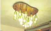  ??  ?? Dhaasoo’s hanging chandelier is made from discarded wine bottles and wood.