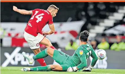  ??  ?? Up and running: Andreas Weimann opens the scoring for Bristol City with a clinical finish past Derby goalkeeper Kelle Roos