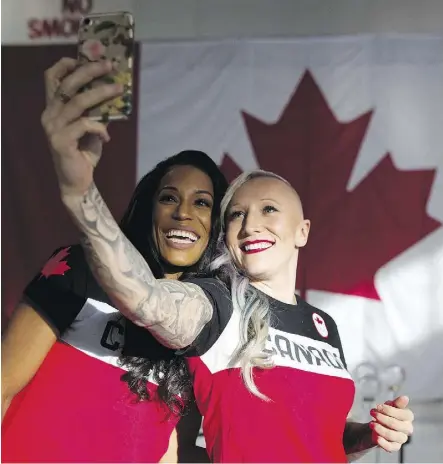  ?? LEAH HENNEL ?? Bobsled athletes Kaillie Humphries, right and Phylicia George take a selfie after they were named to Canada’s Olympic team in Calgary on Wednesday. The pairings of drivers and brakemen for the sleds has yet to occur, but the belief is Humphries and...