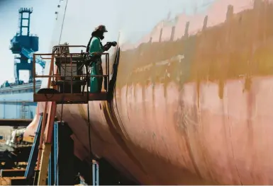  ?? ROBERT F. BUKATY/AP 2018 ?? A welder works on the hull of a Zumwalt-class destroyer in the shipyard at Bath Iron Works in Bath, Maine.