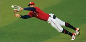  ?? The Associated Press ?? Minnesota Twins center fielder Byron Buxton makes a diving catch of a fly ball off the bat of Texas Rangers’ David Dahl in the seventh inning of Tuesday’s game in Minneapoli­s.