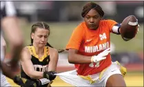  ?? ORLIN WAGNER — THE ASSOCIATED PRESS ?? Ottawa defensive end Jennifer Anthony, left, tackles Midland’s JaNasia Spand (11) during an NAIA flag football game last month in Ottawa, Kan.