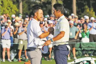  ?? CURTIS COMPTON/ASSOCIATED PRESS ?? Xander Schauffele greets Matsuyama after Matsuyama won the Masters. Schauffele tied for third with Jordan Spieth.