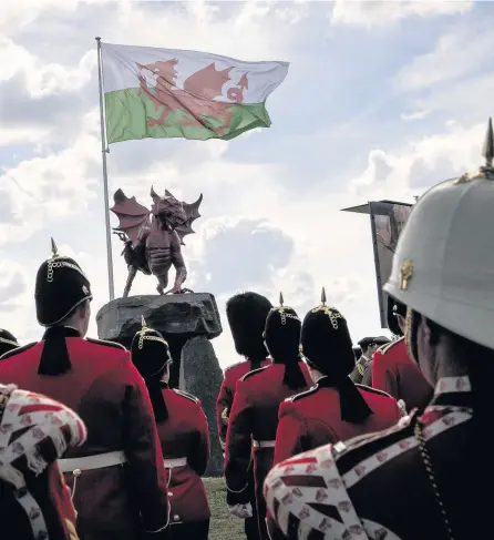  ?? Corporal Tom Evans (RLC) ?? &gt; The Regimental Band and Corps of Drums of The Royal Welsh pay tribute at the service to commemorat­e the Centenary of the Third Battle of Ypres, Passchenda­ele, during the Welsh National Service of Remembranc­e at the Welsh Memorial in Flanders yesterday