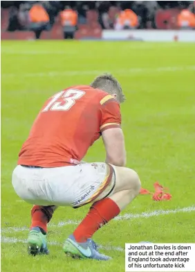  ??  ?? Jonathan Davies is down and out at the end after England took advantage of his unfortunat­e kick