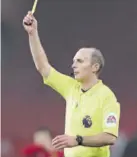  ?? (Photo: AFP) ?? English Referee Mike Dean shows a yellow card to Southampto­n’s English defender Kayne Ramsay during the English Premier League match against Manchester United at Old Trafford recently.