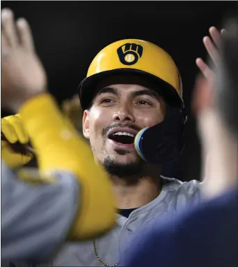  ?? NICK WASS — THE ASSOCIATED PRESS ?? Milwaukee Brewers’ Willy Adames is congratula­ted in the dugout after his three-run home run against the Baltimore Orioles during the fifth inning of a baseball game Friday, April 12, 2024, in Baltimore.