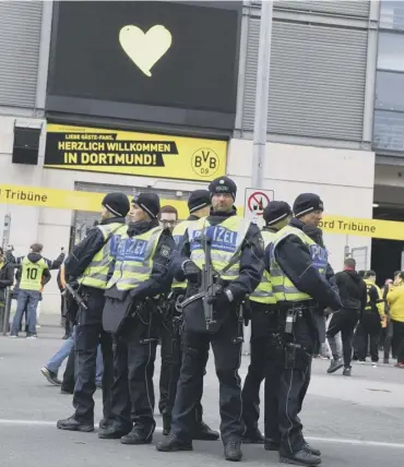  ?? PICTURE; AP ?? 0 Armed police patrol the streets of Dortmund yesterday
