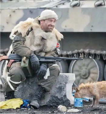  ?? VADIM GHIRDA/THE ASSOCIATED PRESS ?? A Russian-backed rebel rests in Debaltseve, Ukraine, in a photo taken last February. A ceasefire reached in August has seen a sharp decline in casualties, but the UN said Wednesday another 47 civilians died in the period between Aug. 16 and Nov. 15. Since Nov. 15, six more have been killed and 21 wounded.