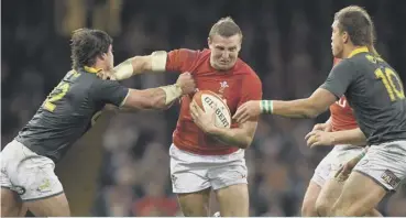  ??  ?? Hadleigh Parkes hands-off Francois Venter as Wales ended their autumn series with a home win.