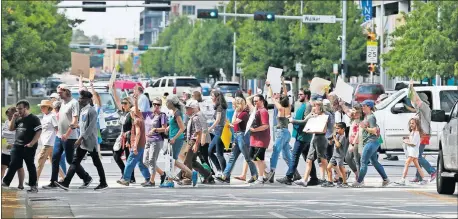  ?? [NATE BILLINGS/ THE OKLAHOMAN] ?? People cross Sheridan Avenue as they march south on Hudson Avenue during the Oklahoma City Climate Strike.