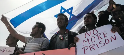  ?? TSAFRIR ABAYOV / THE ASSOCIATED PRESS FILES ?? Asylum-seekers march during a protest in February in Israel. Prime Minister Benjamin Netanyahu’s office said Monday it has reached an agreement with the UN to deport African asylum seekers to Western countries.