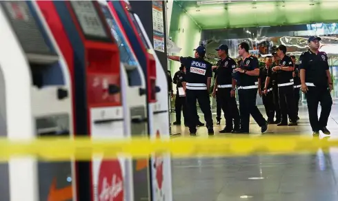  ??  ?? Ready to roll: The police forensic team arriving at the crime scene at KLIA2.