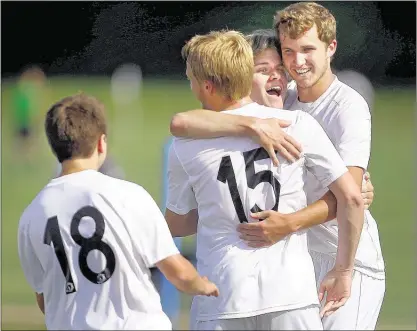  ?? PHOTOS BY JIM WEBER/THE COMMERCIAL APPEAL ?? Houston High’s Corey Brown (15) celebrates a goal with teammates Joshua Moss (right) and Peyton McKnatt (center) against Murfreesbo­ro Oakland in the AAA quarterfin­als on Tuesday. McKnatt also scored in the Mustangs’ 4-0 victory.