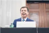  ?? STEFANI REYNOLDS/GETTY ?? Pete Buttigieg, the nominee for transporta­tion secretary under President Joe Biden, smiles during his Senate confirmati­on hearing Thursday.