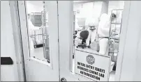  ??  ?? JOB HAZARD: Workers wearing hazardous-materials suits check an off-site facility this week for suspicious substances addressed to top Pentagon officials.