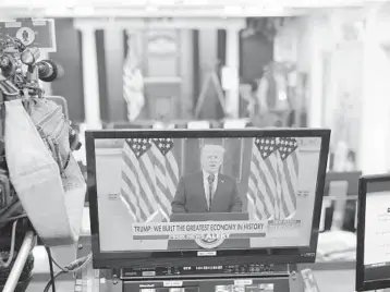  ?? MANDEL NGAN/GETTY-AFP ?? An image of President Trump speaking in a video is seen on a monitor Tuesday in the Brady Briefing Room of the White House. Trump delivered his farewell address to the nation via a video released on YouTube.