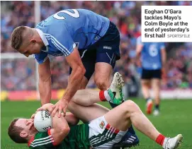  ?? SPORTSFILE ?? Eoghan O’Gara tackles Mayo’s Colm Boyle at the end of yesterday’s first half