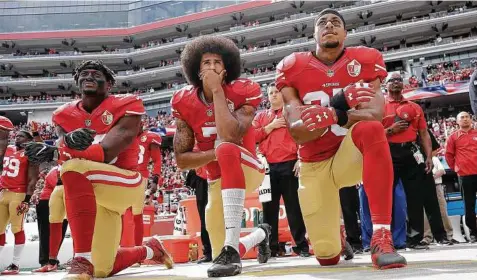  ?? Marcio Jose Sanchez / Associated Press ?? 49ers quarterbac­k Colin Kaepernick, center, made waves this NFL season by kneeling during the national anthem to protest police brutality across the country.