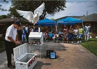  ?? Marie D. De Jesús / Staff photograph­er ?? White doves are released in memory of Chaz Jones in August. He left two sisters, his mother and a large extended family that used to gather at his mother’s house in Sunnyside for Soul Food Sundays.