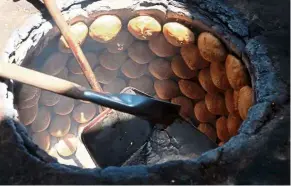  ??  ?? Heong pneah biscuits baking in a traditiona­l oven.