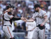  ?? DERRICK TUSKAN — THE ASSOCIATED PRESS ?? San Francisco pitcher Carlos Rodon, right, celebrates with catcher Austin Wynns after defeating San Diego on Saturday.