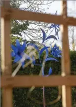  ??  ?? Above: The sculpture that Phil Davis welded together is bright blue, consists of a butterfly and floral shapes, stands more than three metres tall and was built to give something interestin­g to the view out the living room window.