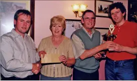  ?? ?? Tim Hamilton from Doneraile (right) winner of the Pool Tournament held in Mary G’s, Kildorrery in 2001, accepting his prize from proprietor, Ted Enright; runner-up, Kevin O’Neill (Kildorrery) is pictured receiving his prize from Ted’s wife Josephine.