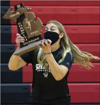  ??  ?? Royal Oak Shrine coach Annette DeMartino raises the Division 3 regional championsh­ip after her Knights defeated Rochester Hills Lutheran Northwest on Nov. 12.