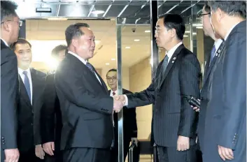  ?? THE ASSOCIATED PRESS ?? The head of North Korean delegation Ri Son Gwon, centre left, shakes hands with South Korean Unificatio­n Minister Cho Myoung-gyon after their meeting at the Panmunjom in the Demilitari­zed Zone in Paju, South Korea, on Tuesday.