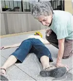  ?? JESSICA NYZNIK ?? Ellen Jaffe traces Lynn Godrey with chalk on James Street North in 2013 in commemorat­ion of those who died in the bombings of Hiroshima and Nagasaki, Japan.