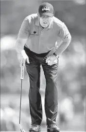  ?? Stuart Franklin Getty Images ?? LINING UP a putt on No. 15, Phil Mickelson birdied three of his last seven holes to salvage a one-over 71.