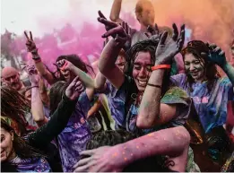  ?? — AFP ?? People dance as they take part in the Colour Sky Festival at Kadikoy district in Istanbul on Sunday.